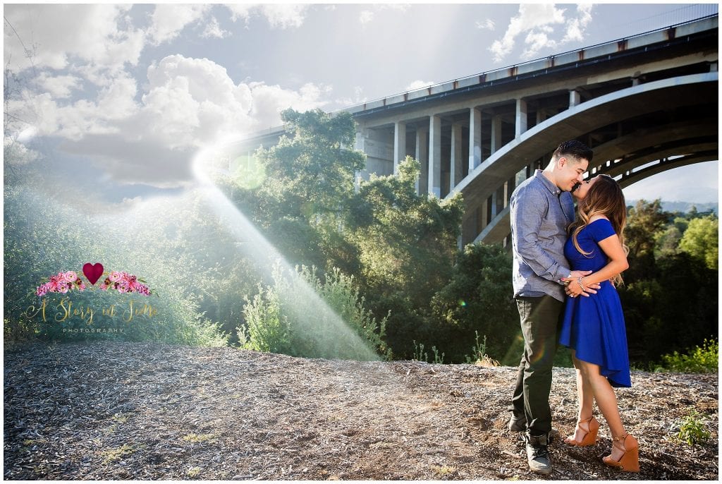 Pasadena Bridge. Clouds and sun flare and a couple in love. 